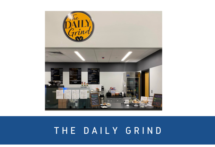 The Daily Grind coffee shop counter with delicious baked goods on display.