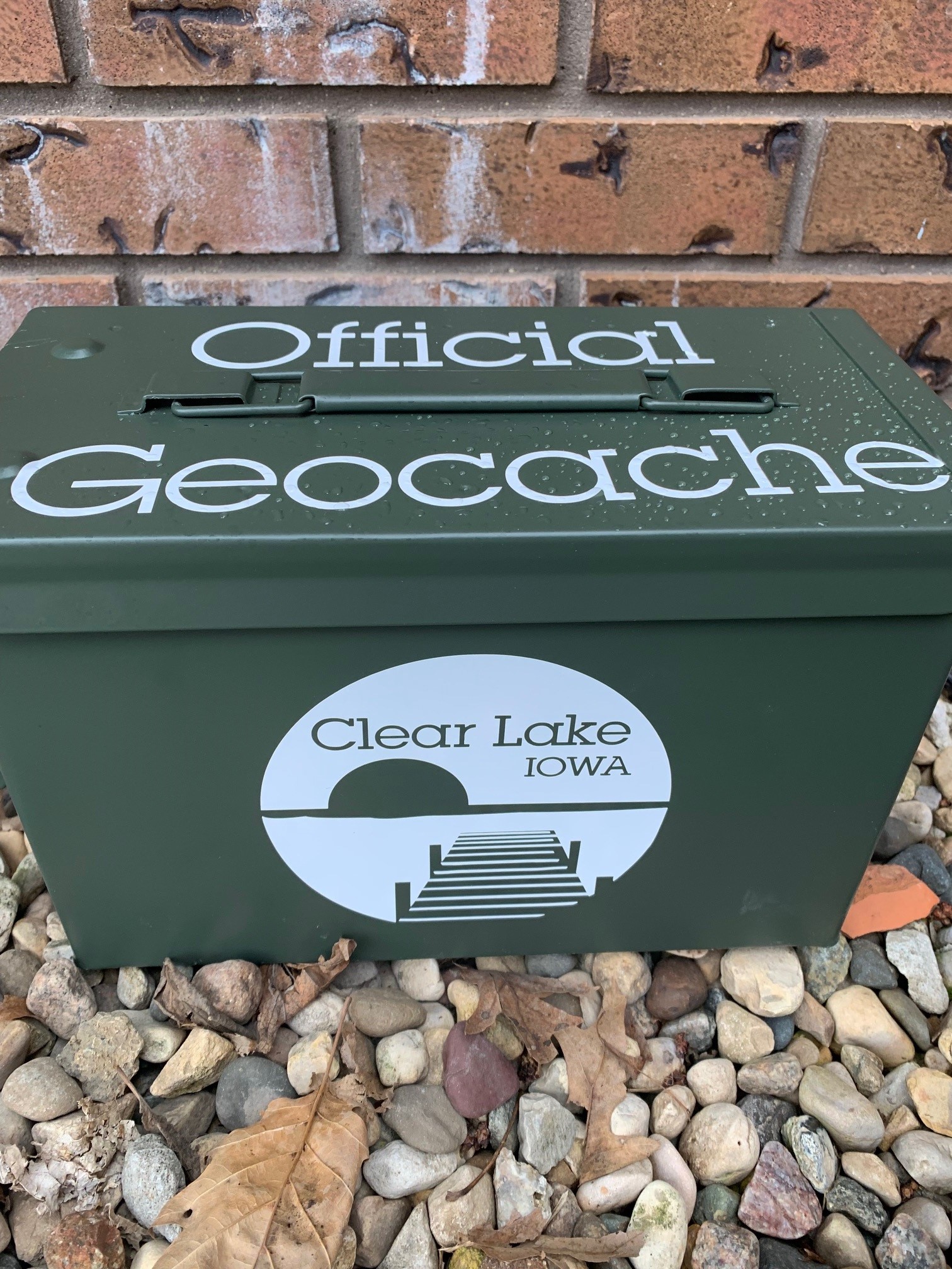 Geocache box that says Official Geocache Clear Lake Iowa