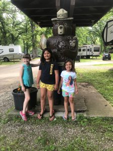 Kids posing with Smokey Bear at McIntosh Woods State Park campground entrance in Ventura, Iowa.
